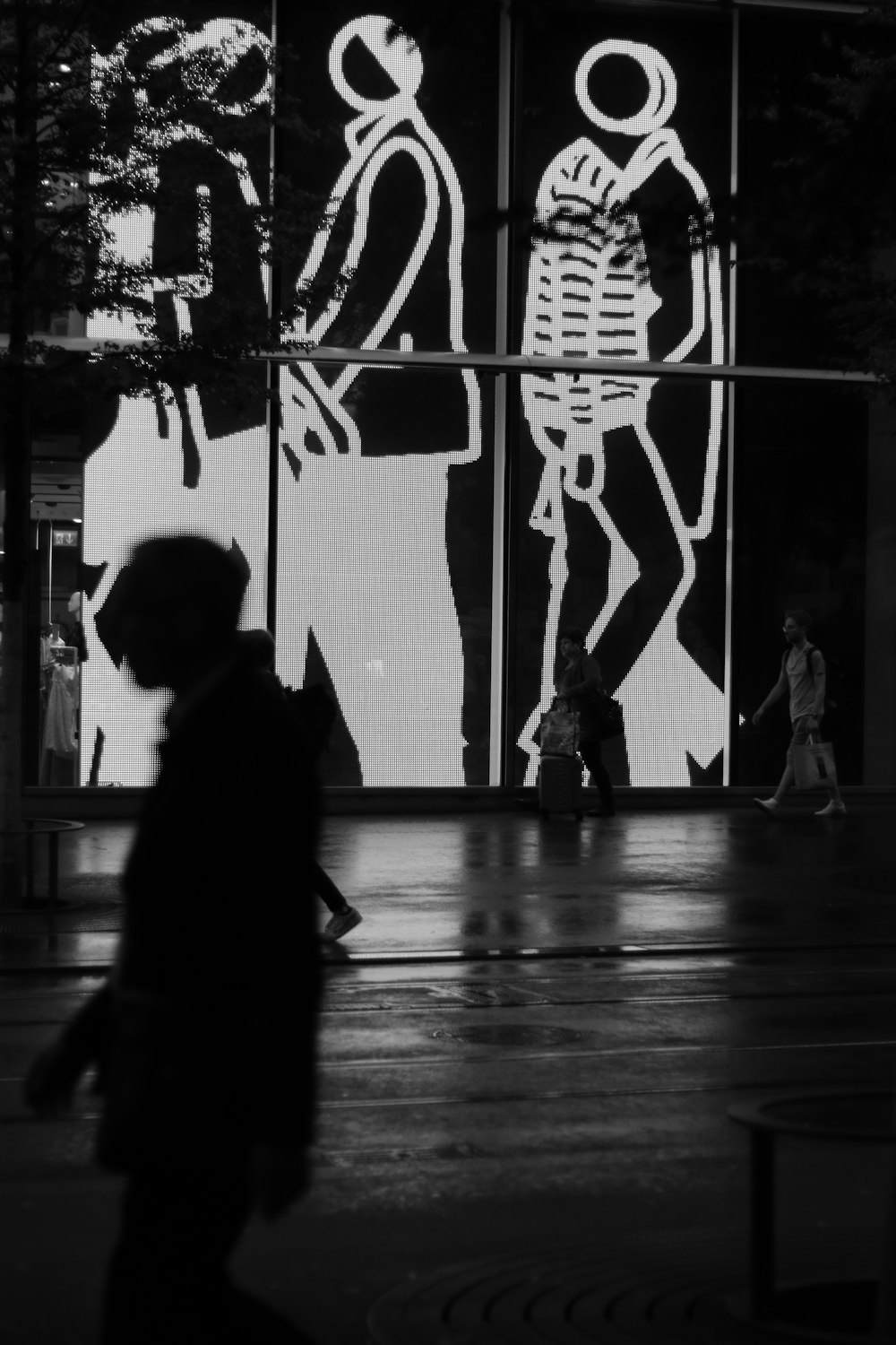 silhouette of man walking near wall