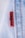 A close-up view of a denim fabric with prominent stitching details. A small red tag with black text is visible, partially showing a brand name. The fabric texture and stitching are clearly defined, illustrating the quality and craftsmanship of the material.