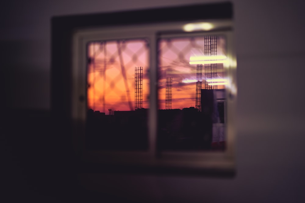 window overlooking black towers during golden hour