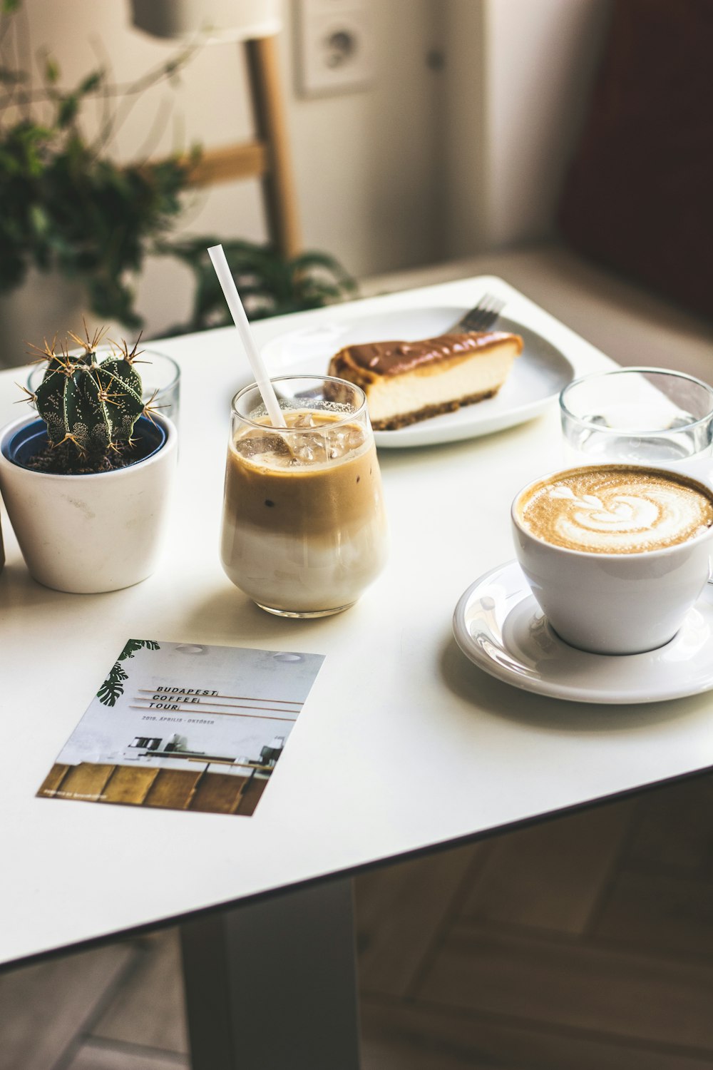 a table topped with a cup of coffee and a plate of food