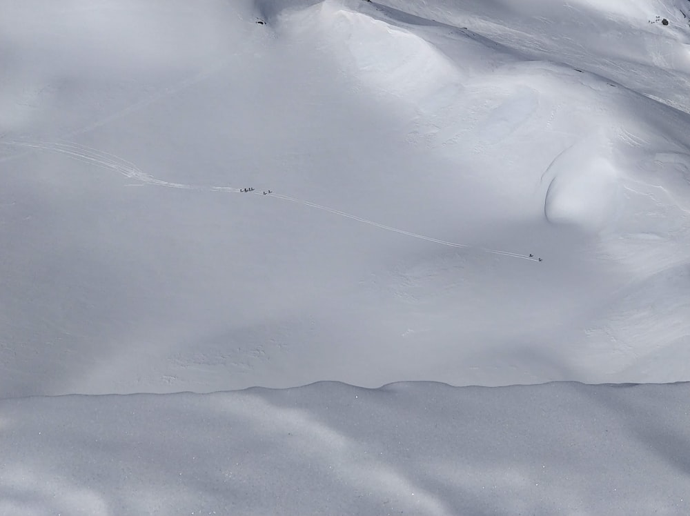 a man riding skis down a snow covered slope