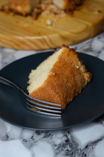 Moist and fluffy air fryer chocolate cake slice on a white dessert plate