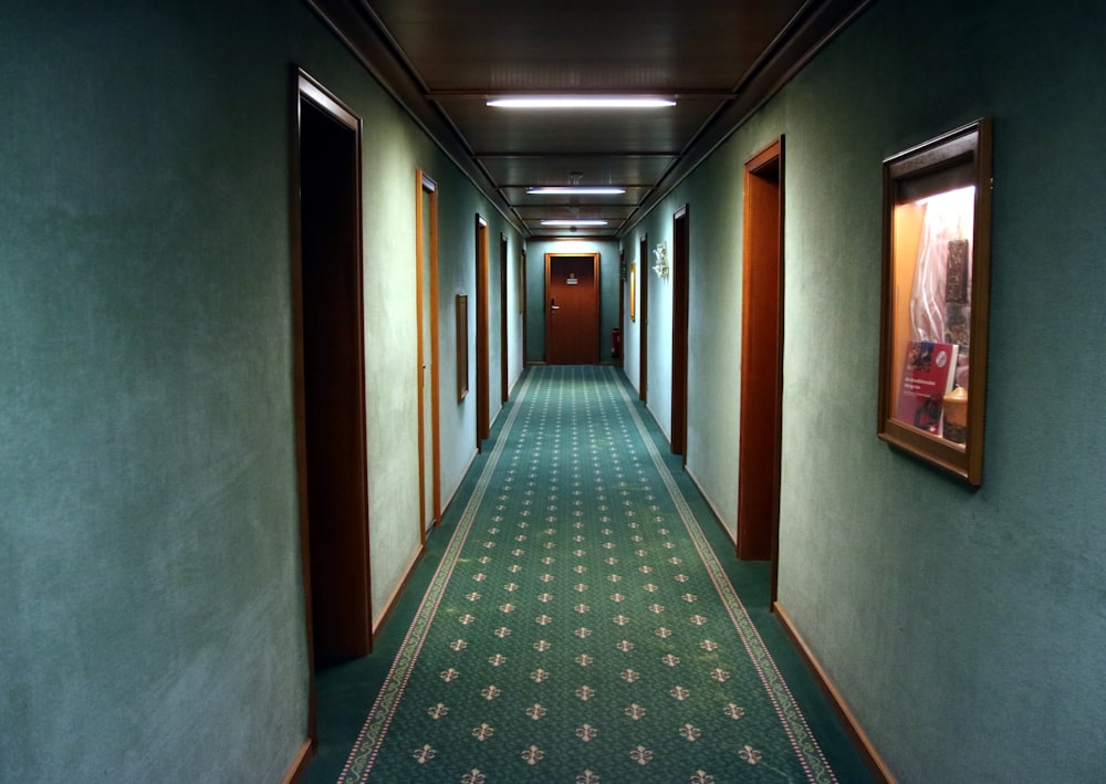 empty hallway with green runner rug