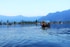 people riding boat on body of water near island