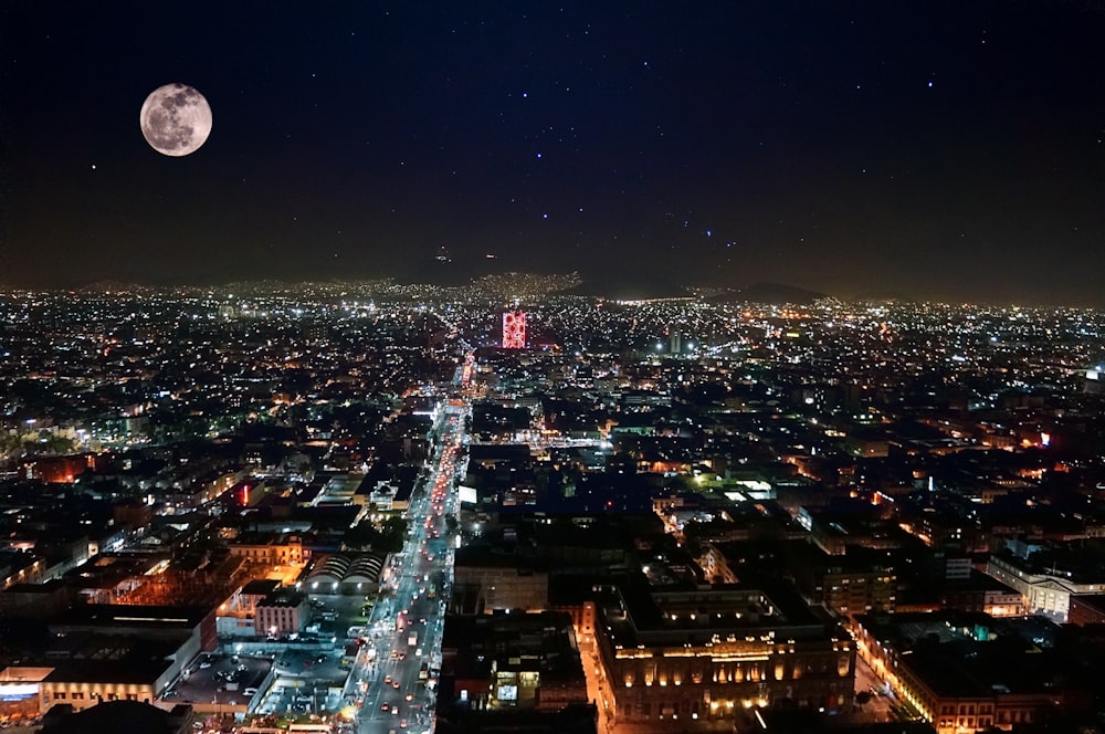 夜のライトアップされた建物の上の満月