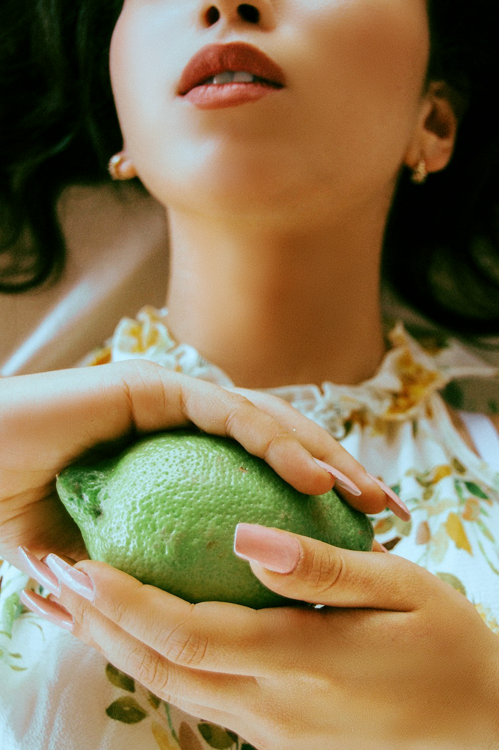 woman holding green lime
