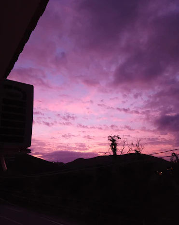 A vibrant sunset view over the hills of Lonavala with travelers enjoying the scenery.