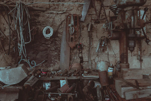 Rustic workshop corner with technical tools and a partially finished 3D-printed part.