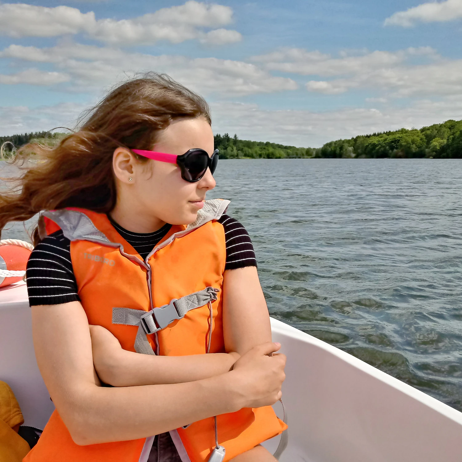 Person wearing a life jacket while traveling on a lake