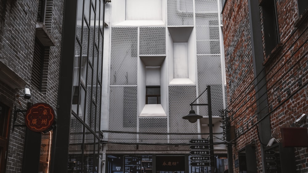 a narrow alley way with a building in the background