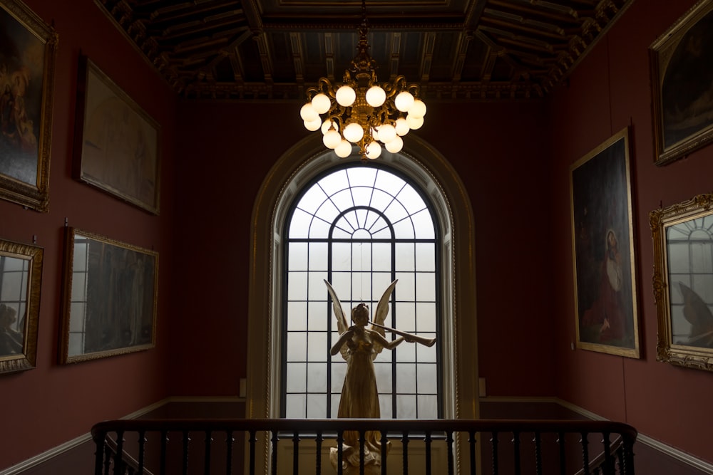 angel statue in front of window