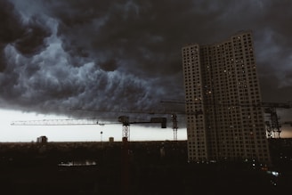 a very tall building under a cloudy sky