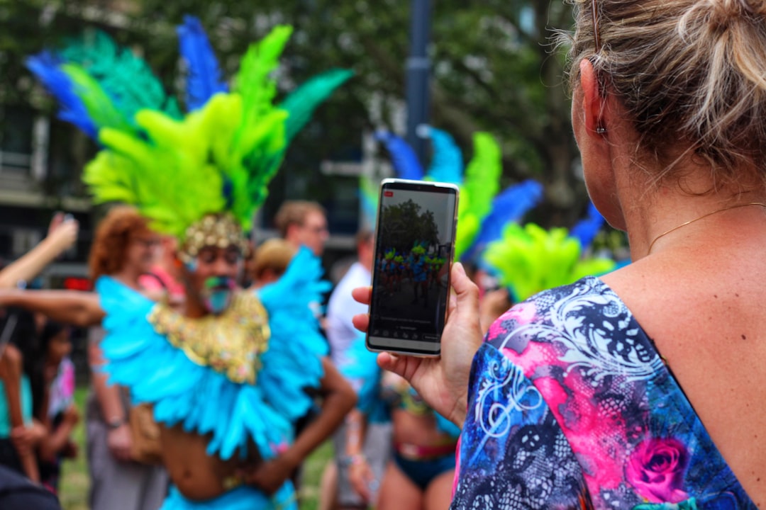 woman taking photo of festival