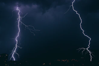 A dramatic scene of two rivals facing off under a stormy sky with lightning.