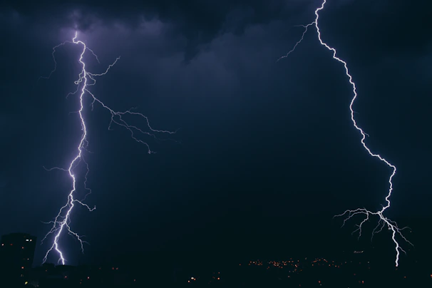 A dramatic scene of two rivals facing off under a stormy sky with lightning.