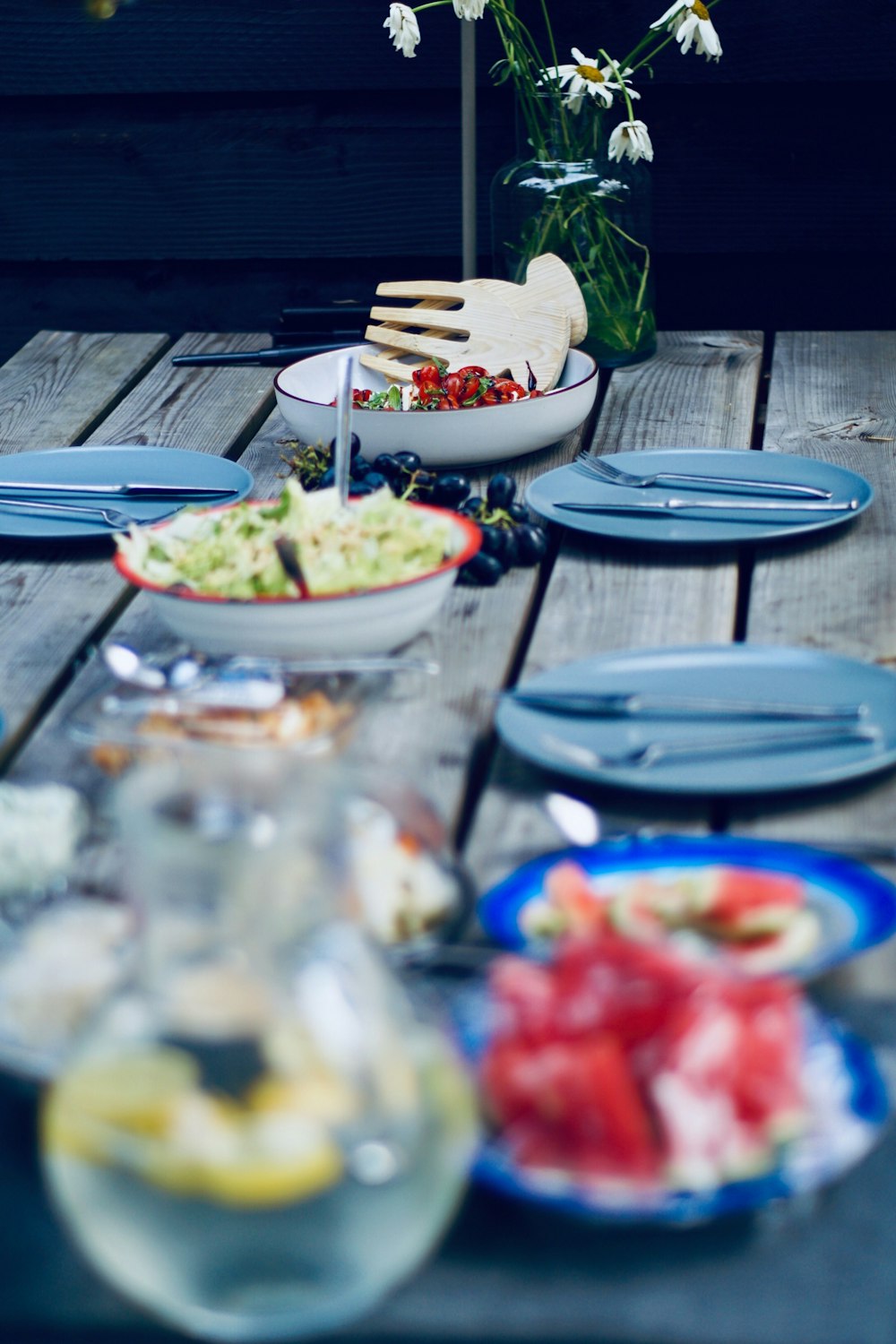 foods in bowl near plates on table