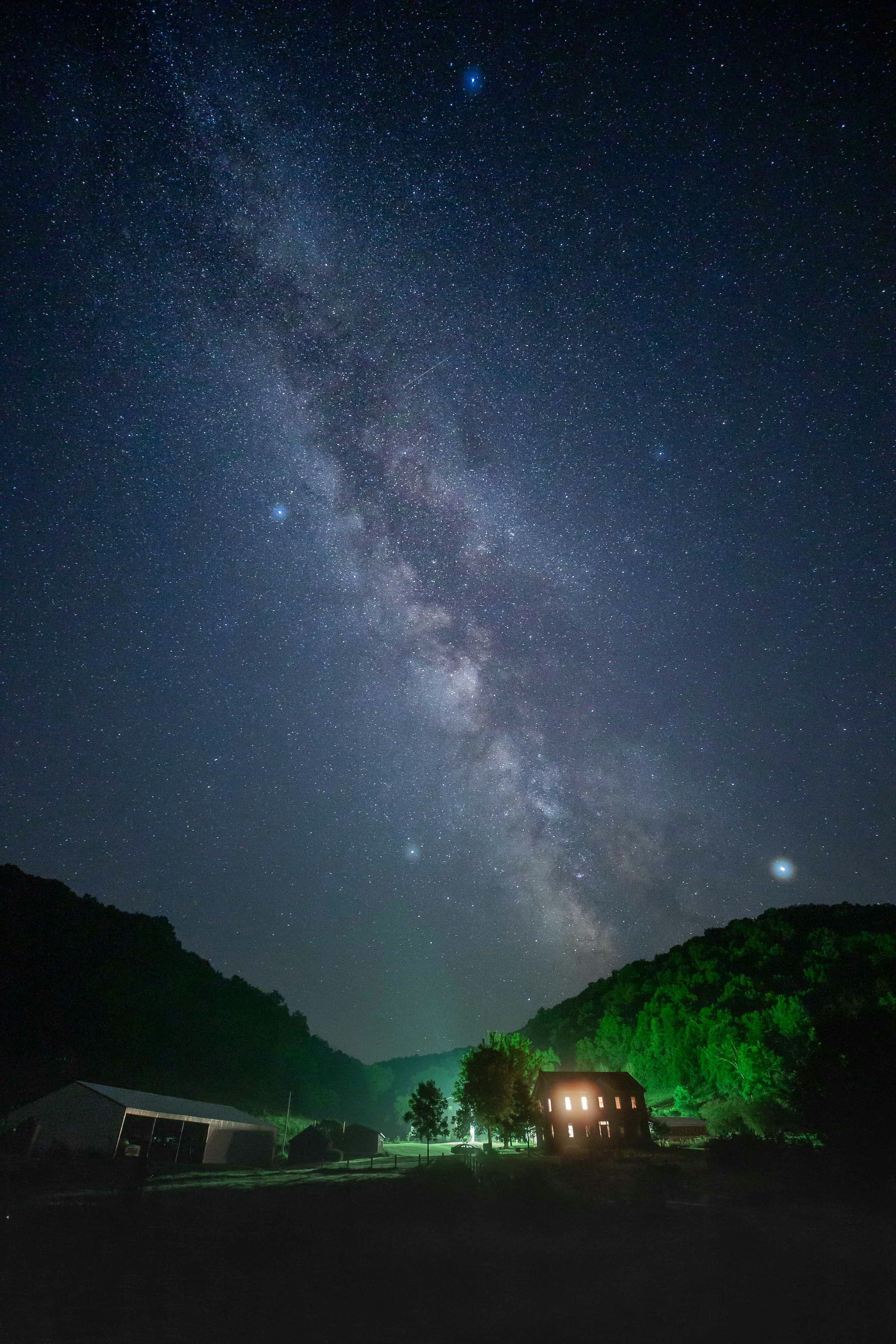 lighted house in countryside at night