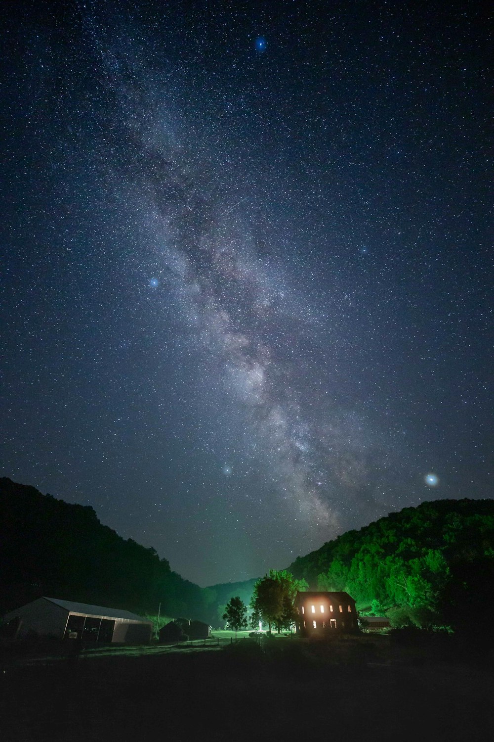 lighted house in countryside at night