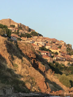 Sunset casting warm hues over ancient stone villages perched on hillside terraces.