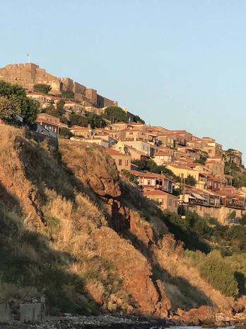Sunset casting warm hues over ancient stone villages perched on hillside terraces.