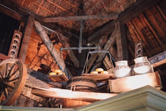 A rustic family dairy farm scene with fresh milk cans and traditional cheese aging on wooden shelves.
