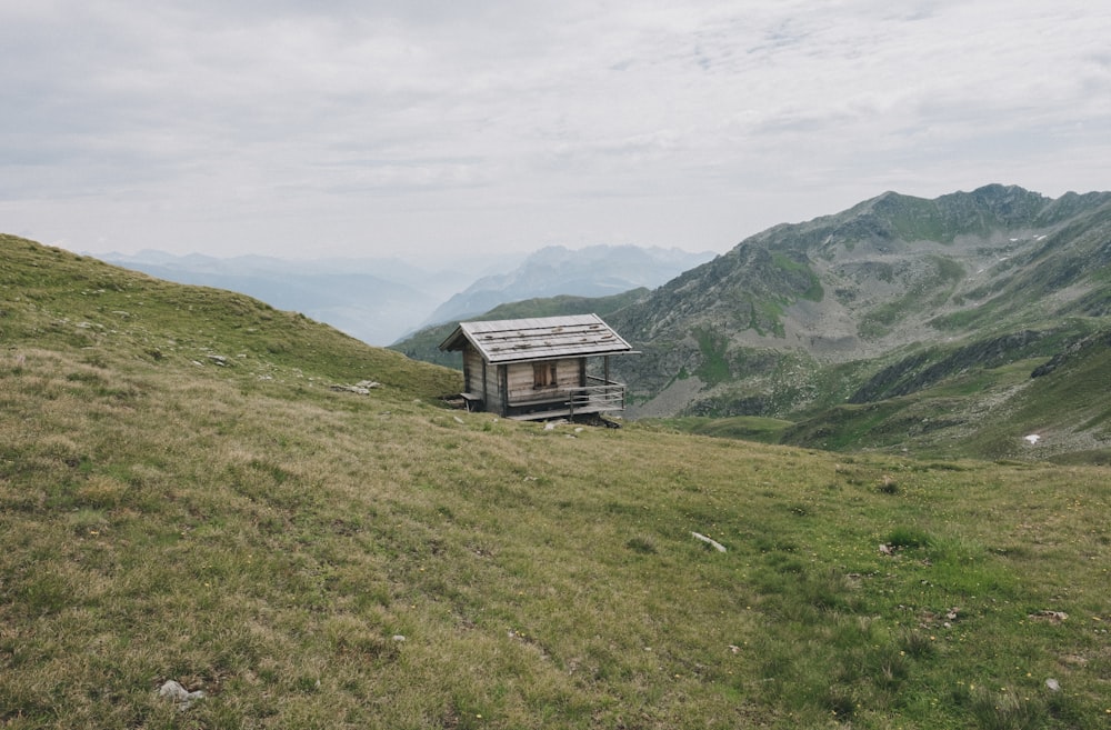 brown wooden cabin on hill