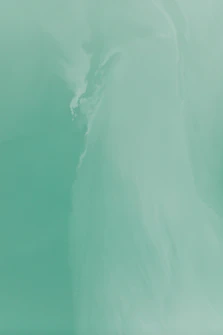 a man riding a surfboard on top of a wave