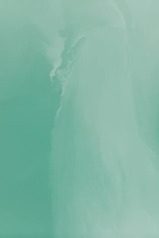 a man riding a surfboard on top of a wave