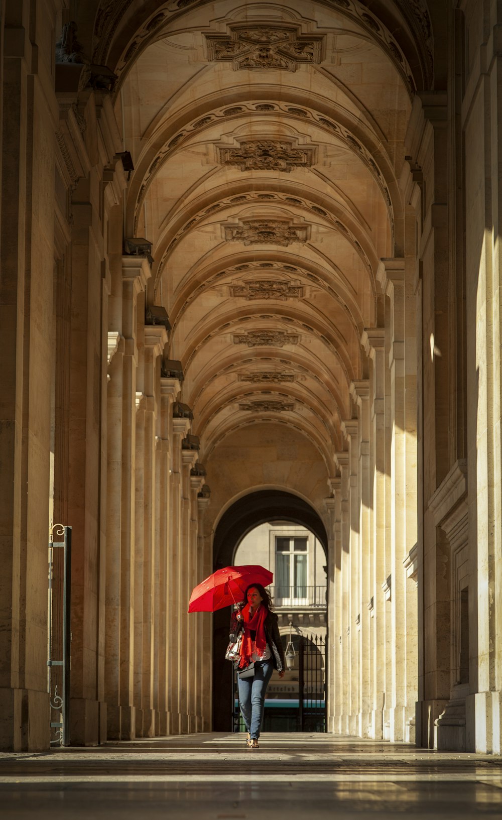 walking holding umbrella walking on building corridor