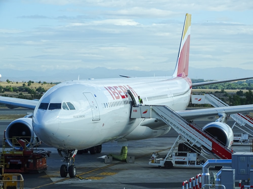 white and red airplane landing