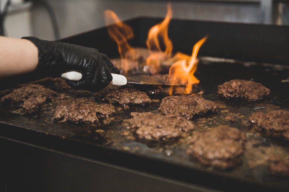 person grilling patties