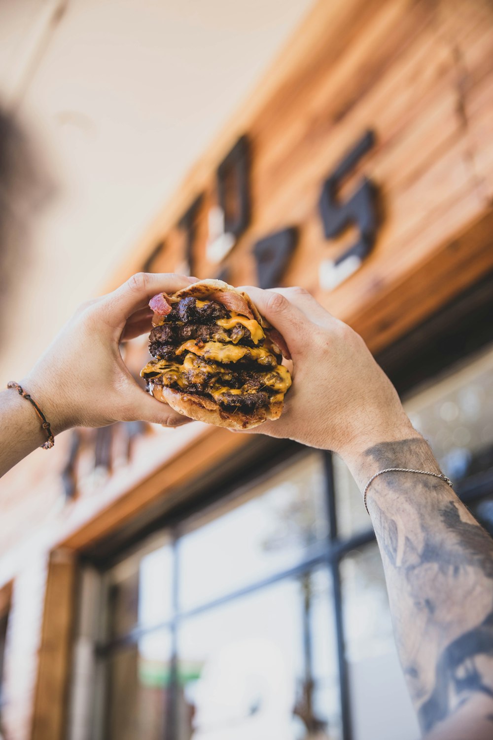 a person holding a doughnut in their hand