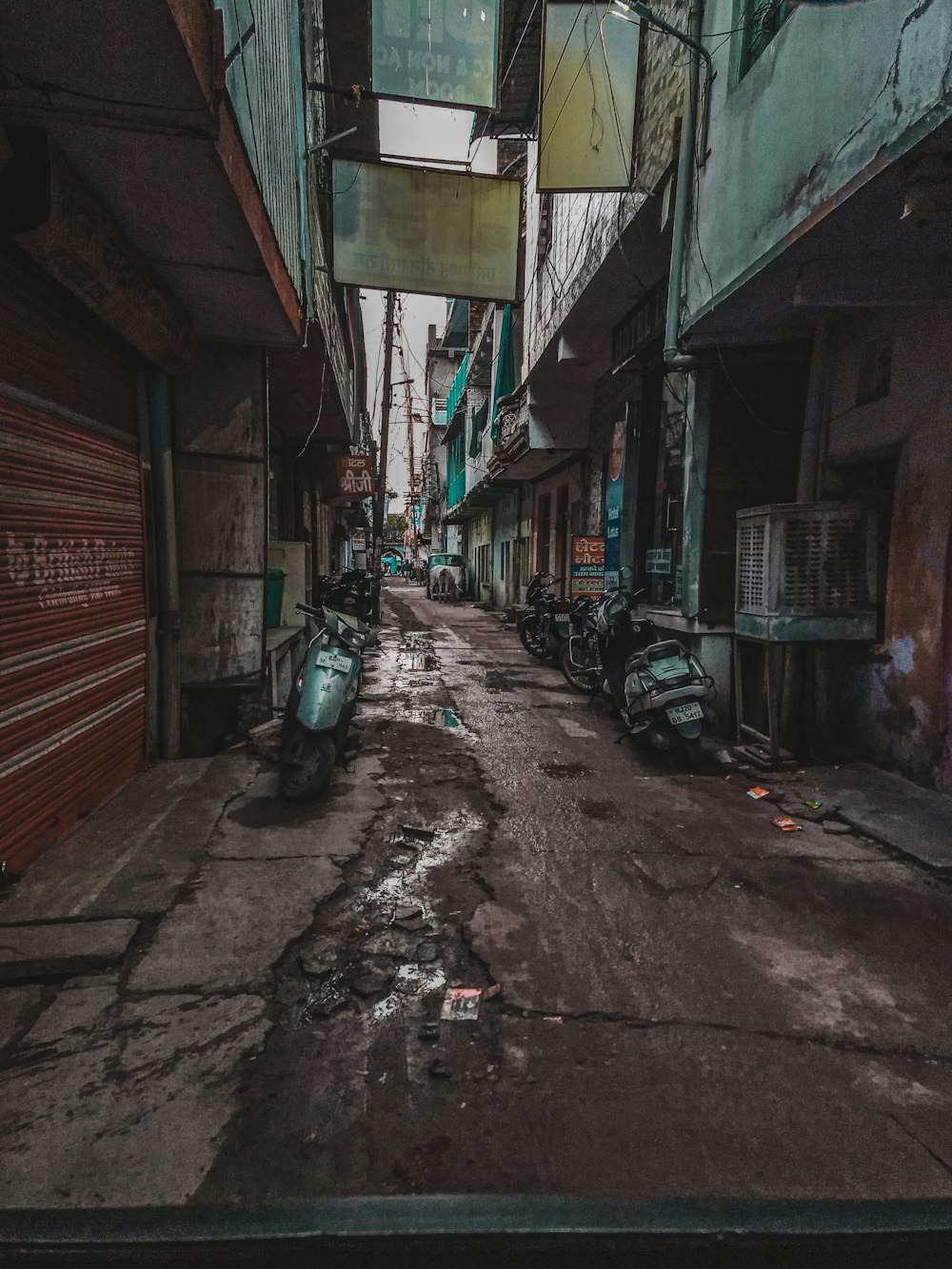 photography of motor scooter parked beside road during daytime