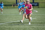Women playing football together on a sunny community field