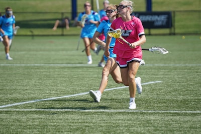 Women playing football together on a sunny community field