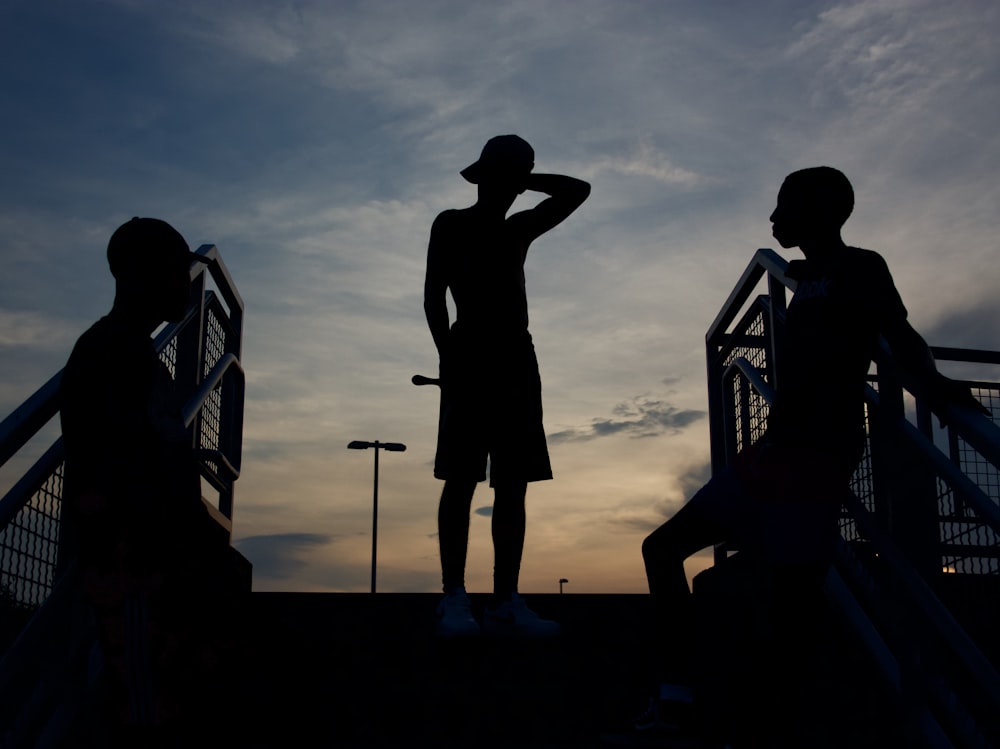silhouette of standing three person
