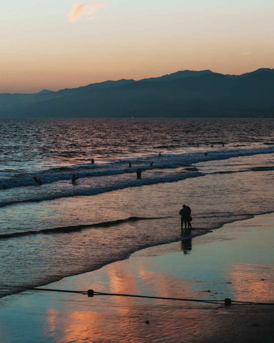 man on shore during golden hour