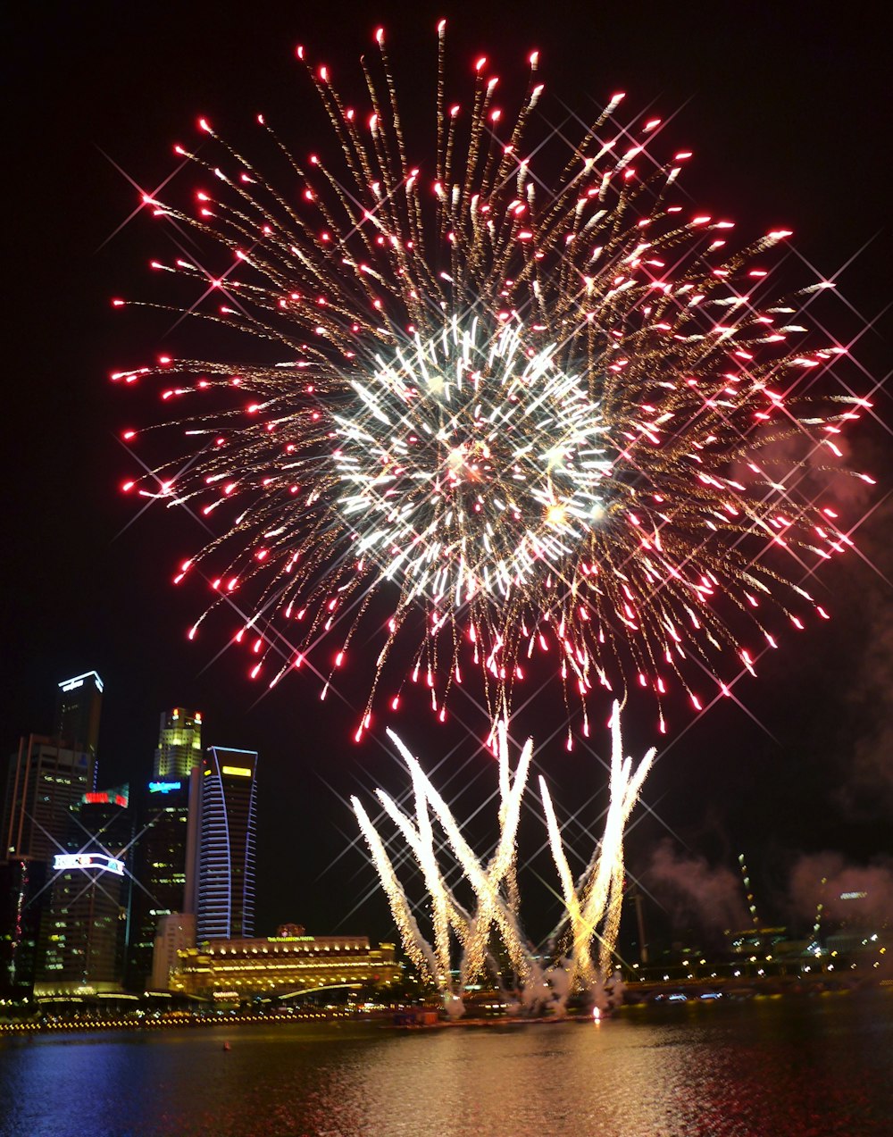 red and white fireworks display near buildings