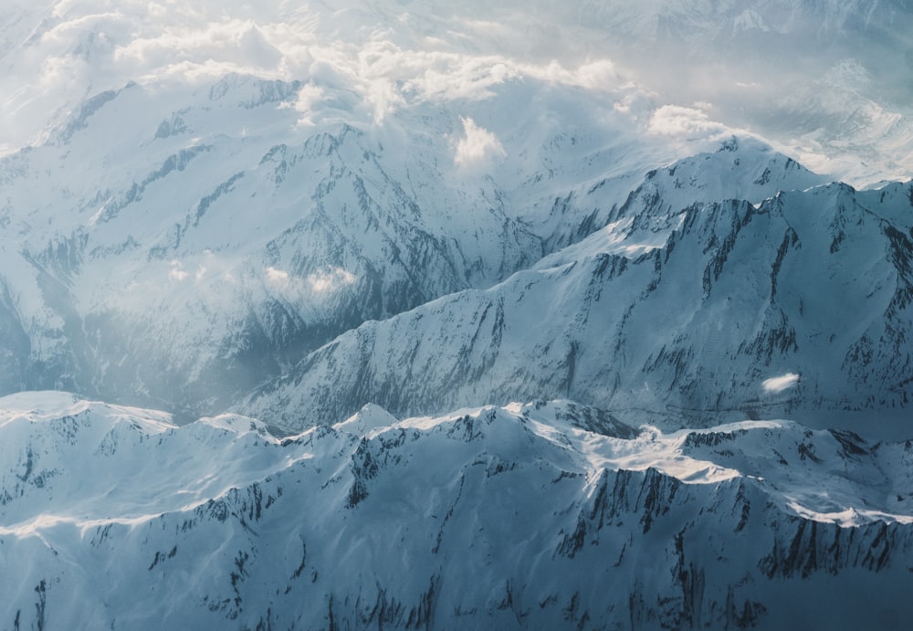 a view of snow covered mountains from an airplane