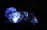 Illuminated polyhedral dice glowing with a bluish hue against a dark background. The light creates a futuristic and mystical atmosphere highlighting the numbers on the intricately shaped dice.