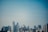 A modern city skyline with tall buildings and clear blue sky during daytime.