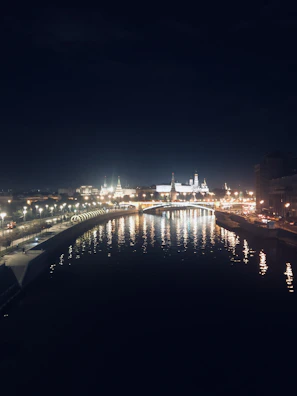 Nighttime city lights reflecting on the Santa Lucia riverwalk.