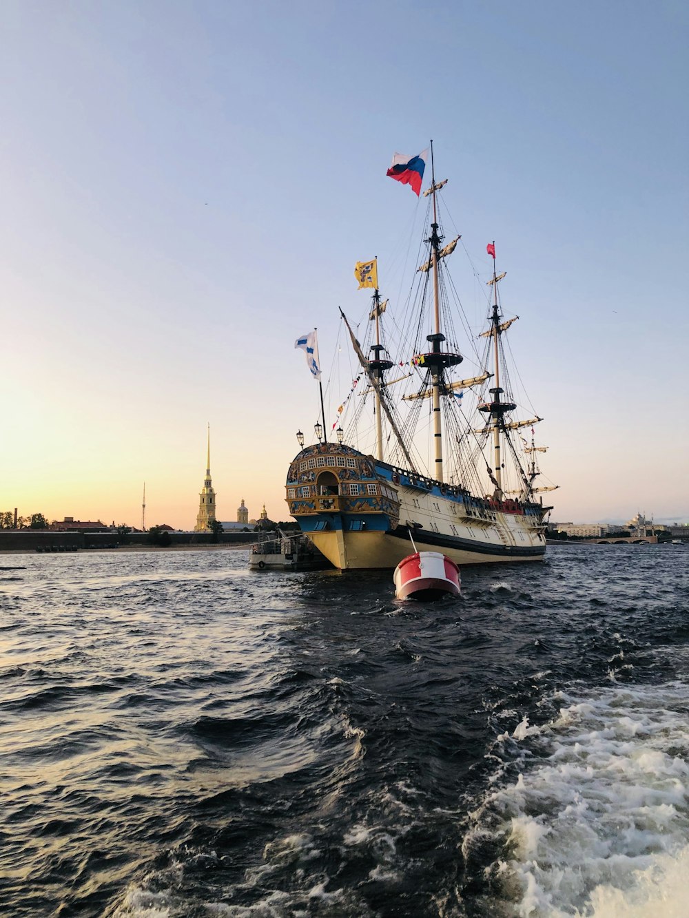 white and blue ship on sea