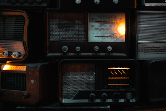 a bunch of old radio's are stacked on top of each other
