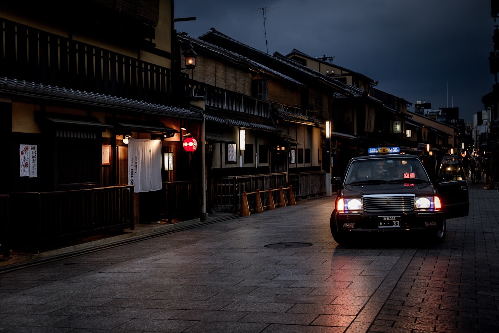 black vehicle parked near buildings