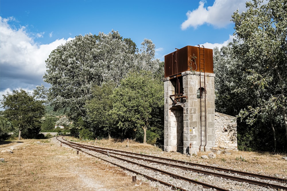 gray and red concrete building beside rail during daytime