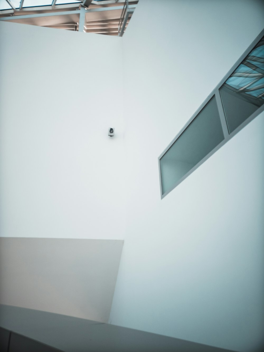 a white room with a skylight and a window
