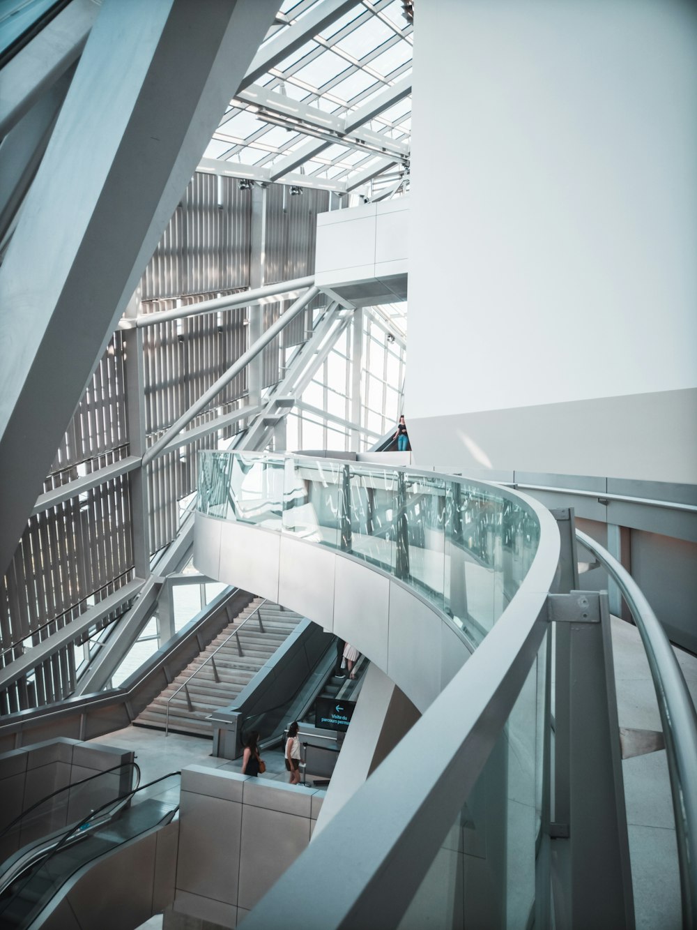 an escalator in a building with people walking up and down it