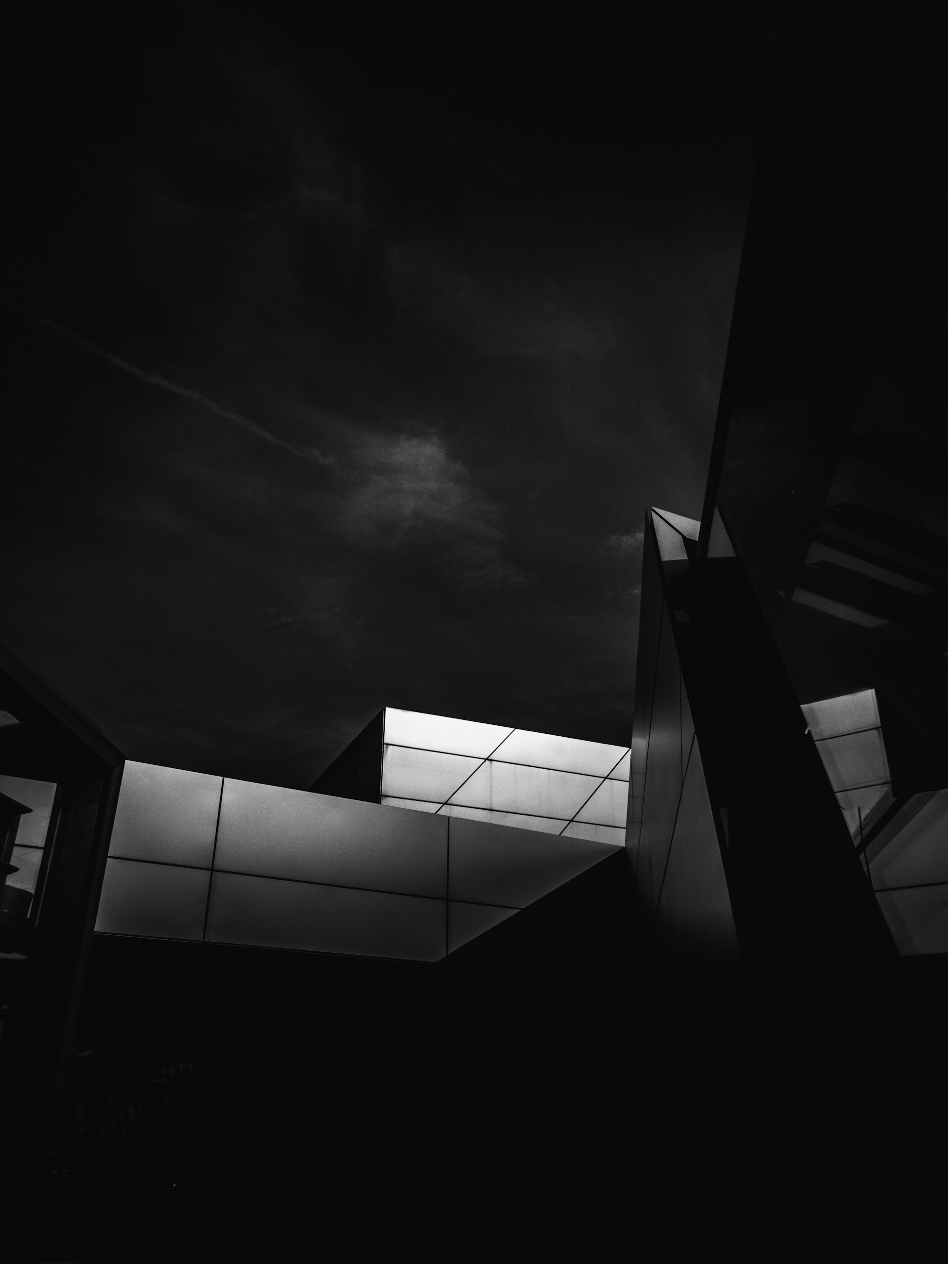 a black and white photo of a building at night