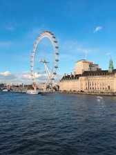 white ferris wheel near calm water